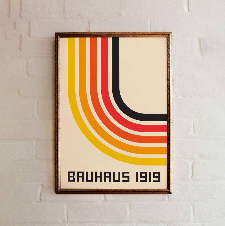 a colorful poster hanging on the wall next to a white brick wall with a wooden frame