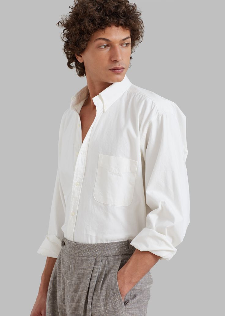 Color: WhiteMidweight woven cotton fabric Oversized fitPointed collar Single chest pocketButton cuffsSlight high low hemCurved hemTonal front button closureUnlined100% CottonGentle Machine Wash or Dry CleanImportedOne Size Timeless Long Sleeve Dress Shirt For Daywear, Timeless Long Sleeve Cotton Shirt, White Long Sleeve Shirt With Welt Pockets, Classic Cotton Shirt For Daywear, Relaxed Fit Long Sleeve Dress Shirt For Daywear, Timeless Cotton Tops With Placket, White Shirt With Welt Pockets And Spread Collar, Classic Shirt With Shirttail Hem And Placket, Classic Unstructured Shirt With Shirttail Hem