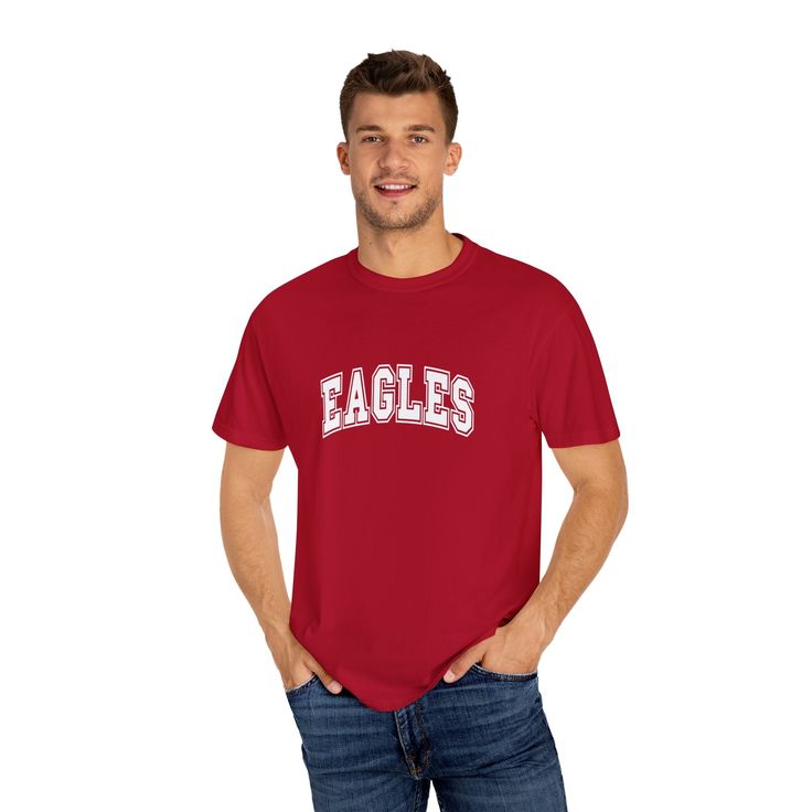 Show your Eagles pride with this classic t-shirt featuring bold, collegiate-style lettering. Perfect for game days, school events, or everyday wear, this tee lets you confidently represent your team. The clean and straightforward design makes it a versatile addition to any fan’s wardrobe. Cheer on the Eagles in style, and let everyone know who you’re supporting with this timeless team t-shirt. University Red T-shirt With Team Name For Fans, Collegiate Jersey T-shirt With Team Logo, Collegiate T-shirt With Team Logo For Sports Events, College Fan Apparel T-shirt With Team Name, Game Day Jersey T-shirt With Letter Print, Collegiate T-shirt With University Logo For Game Day, College Varsity T-shirt With Graphic Print, Jersey T-shirt With Letter Print For Game Day, Sporty University Logo T-shirt With Crew Neck