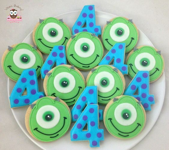 some decorated cookies on a plate with numbers and eyes in the shape of monsters for birthdays