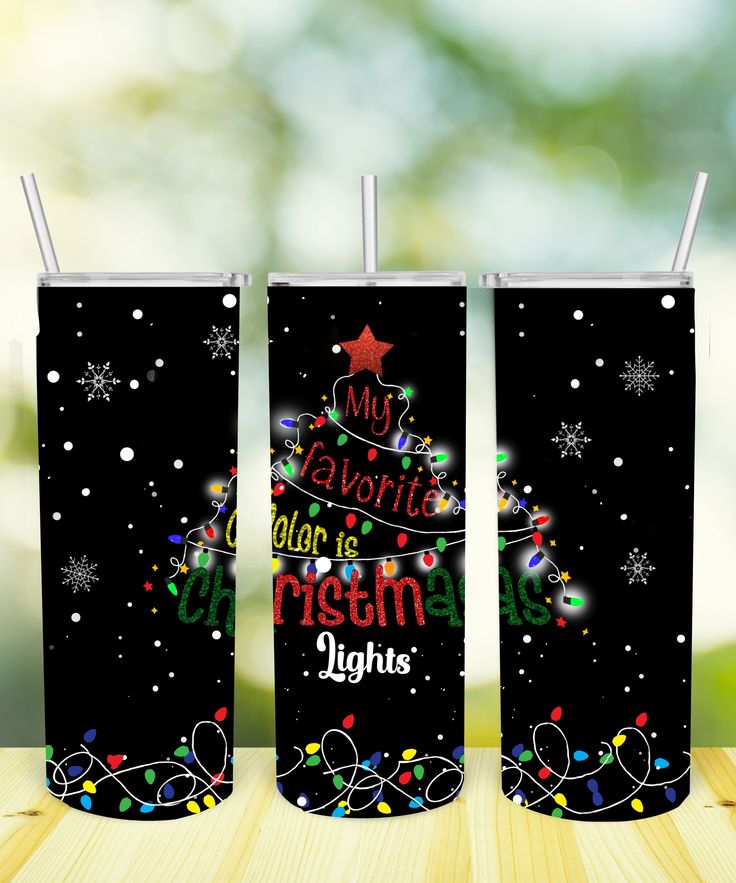 two black tumblers with christmas lights on them