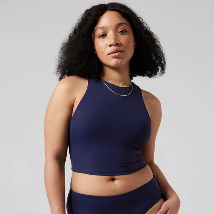 Athleta Conscious Crop Bikini Top A-C New With Tag Color: Dress Blue For: Swim, Surf, Stand-Up Paddleboard, And All Water Sports Feel: Recycled Heco Fabric Is Smooth And Sleek With Powerful Stretch Fave: Crop Silhouette Keeps You Breezy During Your Practice #530870 80% Recycled Nylon/20% Lycra Spandex Lycra Xtra Life Spandex: Long-Lasting Lycra Xtra Life Fabric Stretches And Moves With Her Recycled Heco Fabric Is Smooth And Sleek With Powerful Stretch Machine Wash And Line Dry. Imported. Medium Blue Moisture-wicking Swim Skirt For Sports, Blue Athleisure Swim Skirt For Sports, Sporty Tankini With Built-in Bra For Pool, Sporty Stretch Blue Swim Skirt, Sporty Blue Moisture-wicking Swim Skirt, Blue Stretch Swim Skirt For Sports, Sleeveless Sport Swimwear With Built-in Bra, Blue Swim Skirt For Sports, Blue Sports Swim Skirt