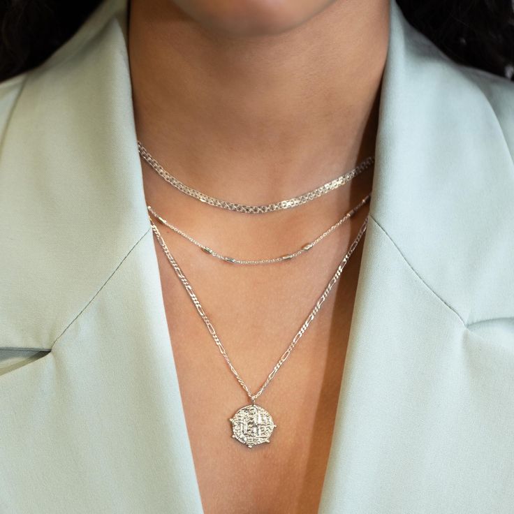 This necklace features a Sterling Silver coin pendant on a Figaro chain. Layer with necklaces from our Patented O collection. Pendant Diameter 0.6in (1.5cm) Figaro chain, 2mm Adjustable chain: 17-19in (44-48cm) When layered, chain length is: 17-21in (44-53cm) Learn more Sterling Silver Spring clasp closure Hypoallergenic, lead and nickel free #290S Silver Cable Chain Jewelry For Layering, Silver Charm Necklace With Satellite Chain, Sterling Silver Medallion Coin Necklace With Chain, Sterling Silver Cable Chain Necklace For Layering, Silver Charm Necklace With Round Pendant And Satellite Chain, Elegant Silver Layered Figaro Chain Necklace, Layering Jewelry With Cable Chain, White Gold Necklace With Coin Pendant, Dainty Silver Link Necklace