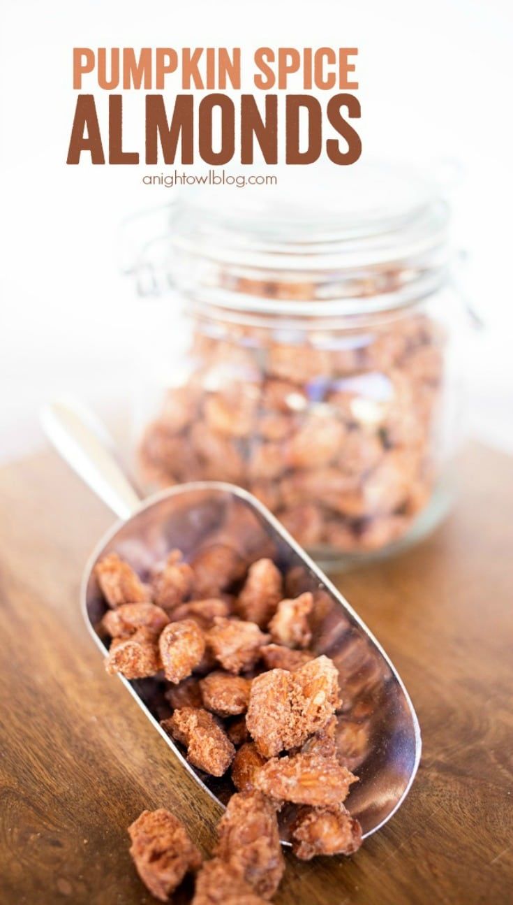 pumpkin spice almonds in a metal spoon on a wooden table with text overlay