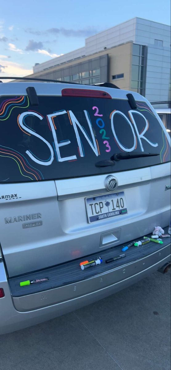 a silver van with the word senior on it