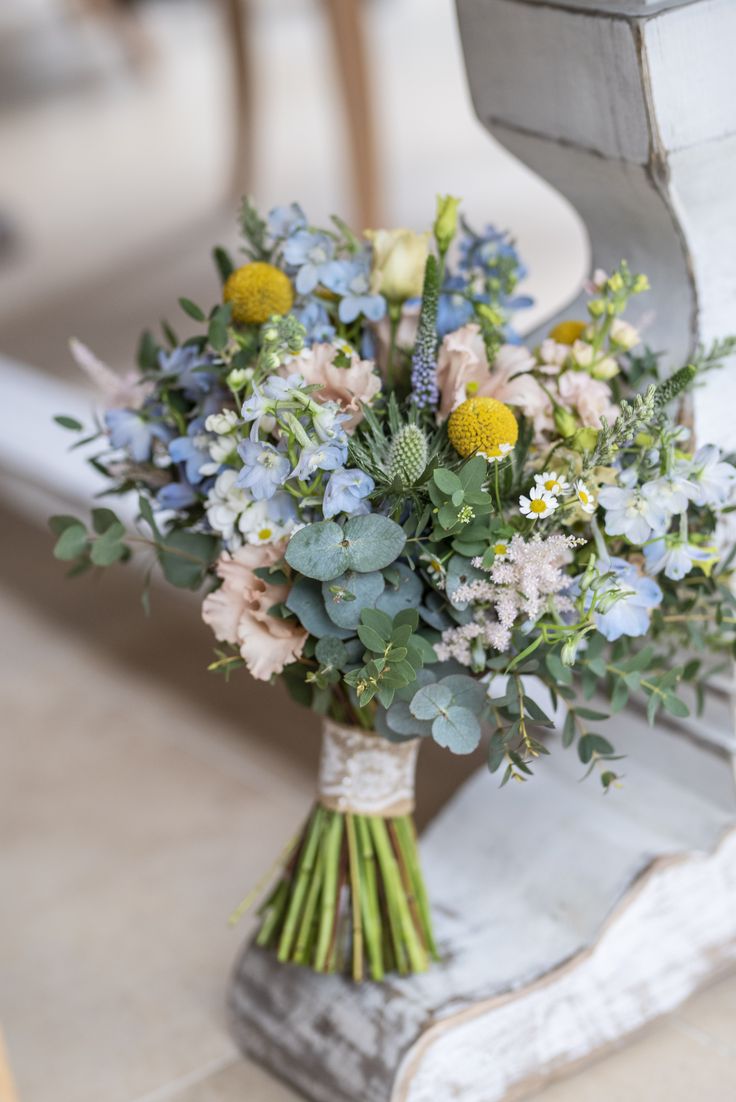 a bouquet of flowers sitting on top of a bench