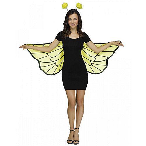 a woman in a black dress and yellow butterfly wings is standing with her arms out