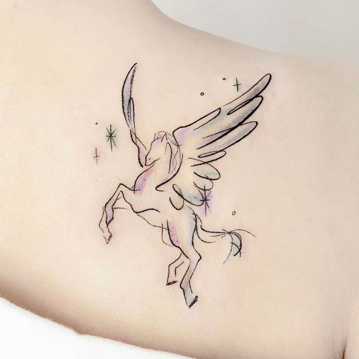 the back of a woman's shoulder with an angel tattoo on it