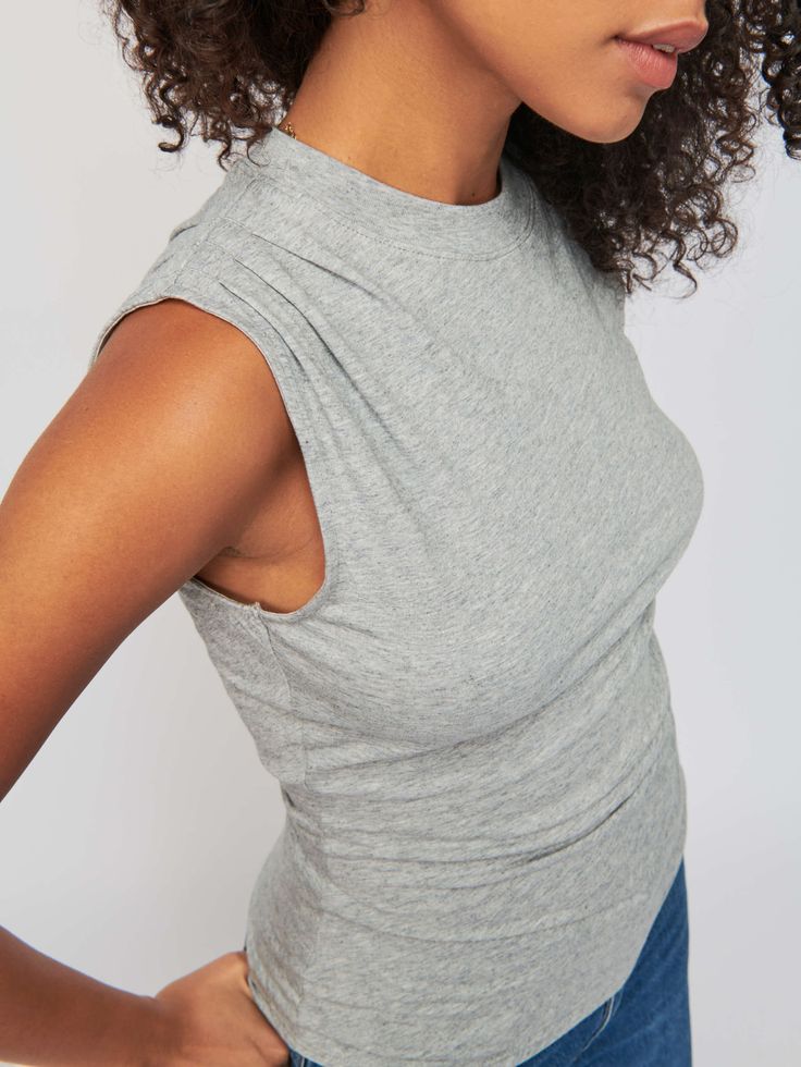 The muscle tee made chic. We added a pintucked shoulder for a little extra texture and a draped fit to accentuate your silhouette. Thank us later. (This one comes in Heather Grey.) | Women's Paz Tank Top in Heather Grey | Ethical Essentials Sleeveless Relaxed Fit Top For Fall, Fitted Cotton Muscle Tee For Layering, Fitted Muscle Tee For Spring, Fitted Muscle Tee For Everyday Spring Wear, Fitted Summer Muscle Tee For Layering, Fitted Muscle Tee For Summer Layering, Chic Stretch Muscle Tee With Crew Neck, Fitted Sleeveless T-shirt, Relaxed Fit Muscle Tee For Layering