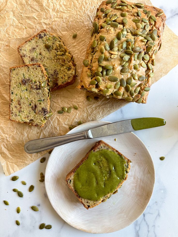 there is a piece of bread on the plate next to it and some green sauce