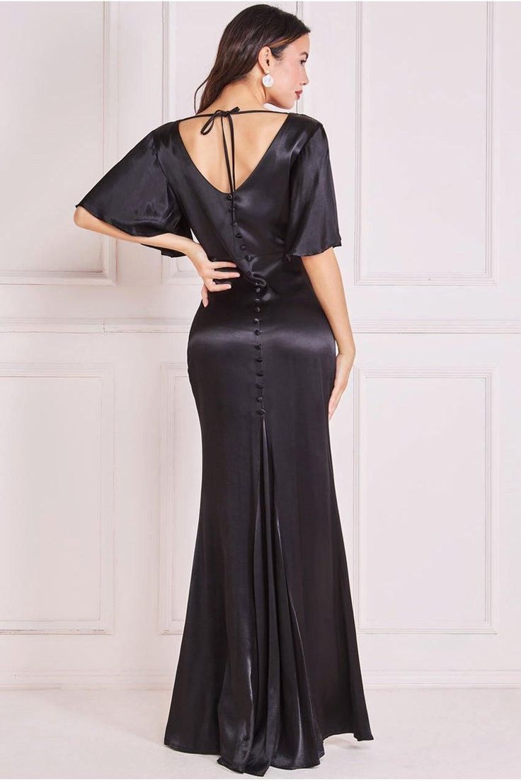 ​Step into pure elegance with our Satin Viscose Cowl Neck Maxi With Train. This exquisite gown exudes luxury with its captivating design and sumptuous materials. The cowl neckline of this gown creates a graceful drape, adding an air of sophistication to your ensemble. Its V-neck back adds a touch of allure, showcasing your shoulders and creating a stunning silhouette. Designed with short sleeves, this maxi dress provides the perfect balance between modesty and glamour. The button detail down the back adds a delightful accent, enhancing the overall charm of the gown. Crafted from the finest satin viscose material, this dress exudes opulence. The fabric's smooth and lustrous texture complements the flowing silhouette, ensuring you feel like royalty with every step you take. Whether you're at Short Sleeve Bridesmaid Dress, Exquisite Gowns, Velvet Maxi Dress, Pure Elegance, Oasis Fashion, Short Bridesmaid Dresses, Black Gown, Cowl Neckline, Chiffon Ruffle