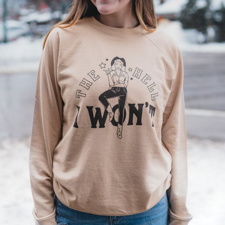 Round up some quirky style with The Hell I Won't unisex slim fit pullover. Featuring a playful The Hell I Won't text and cowgirl graphic, this sand-colored top will show off your fun and rebellious side. 55/45 Cotton/Polyester Slim Unisex Fit Body Length: S-26.5", M-27.5", L-28.5", XL-29.5", 2X-30.5"Chest Width: S-20.5", M-21.5", L-22.5", X:-23.5", 2X-24.5" A Montana Scene Original Design. Printed in Montana. All designs are property of The Montana Scene. All rights reserved. All of The Montana Cowgirl Graphic, Quirky Style, Fit Body, Round Up, Store Fronts, Original Design, Original Designs, Slim Fit