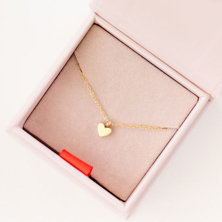 Dress up daily with our Gold Pendant Necklace with Heart Charm. This cute delicate necklace features a dainty gold pendant adorned with a Heart, designed to add a classic touch to an every day. This necklace is a timeless keepsake, we guarantee she will love. Each necklace comes in a gift box. You may also like our Heart Earring. Tiny Heart Necklace For Valentine's Day Gift, Cute Heart-shaped Charm Necklace For Gift, Cute Heart Charm Necklace For Gifts, Gold Heart Pendant Necklaces As Gift, 14k Gold Heart Pendant Necklace For Gift, Heart Shaped Charm Necklace As Gift, Cute Heart Charm Necklaces For Gifts, Heart Shaped Clavicle Chain Charm Necklace As Gift, Tiny Pendant Charm Necklaces For Gift