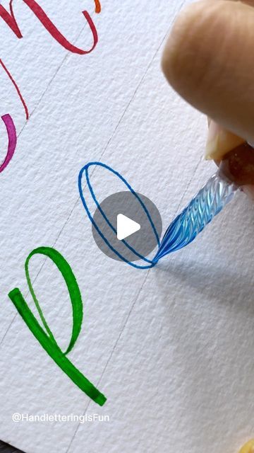 someone is drawing letters on paper with colored crayons