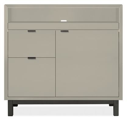 a gray cabinet with two drawers and one door on the bottom, in front of a white background