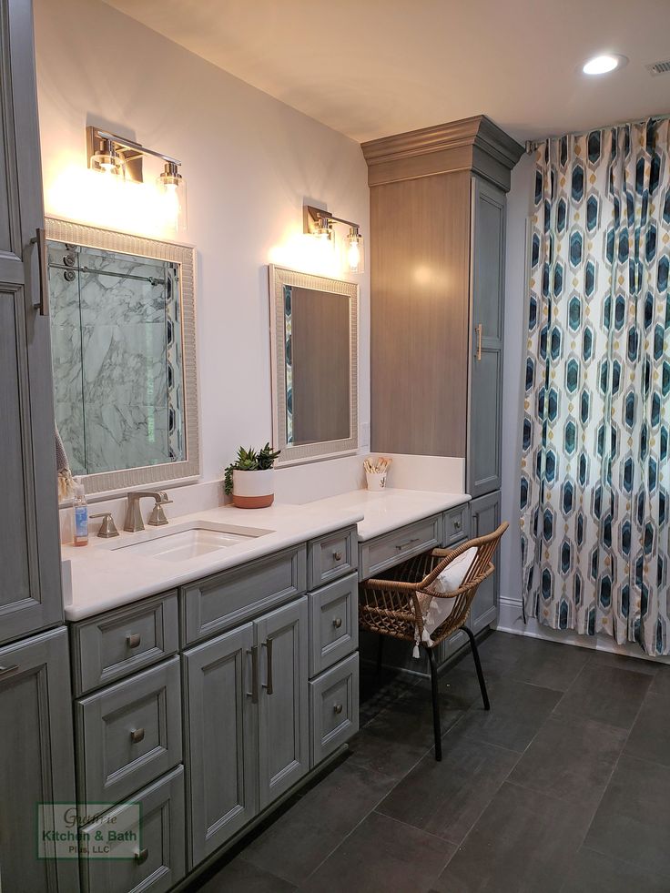 a large bathroom with two sinks and mirrors