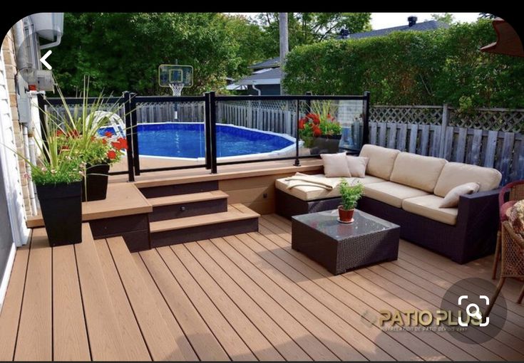 a deck with couches, tables and an above ground pool