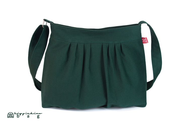 a green purse with white straps on the front and bottom, sitting against a white background