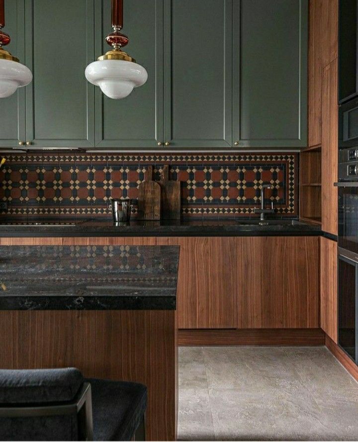 an image of a kitchen setting with green cabinets and black counter tops in the background