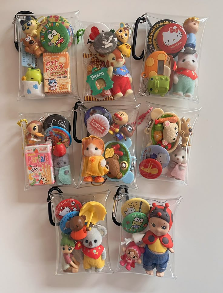 there are many small plastic toys in the bag on the wall hanging from it's hooks