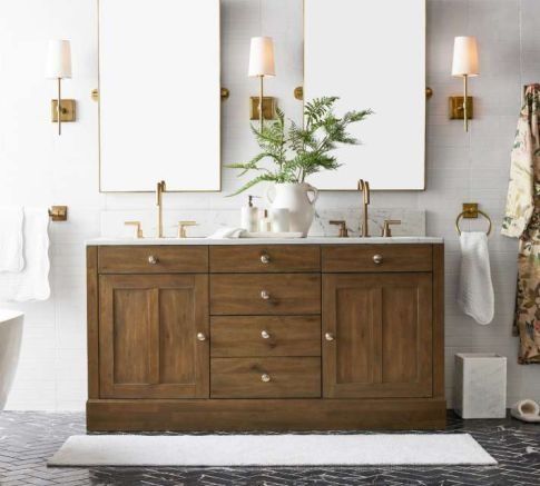 a bathroom with two sinks and three mirrors on the wall next to a bathtub