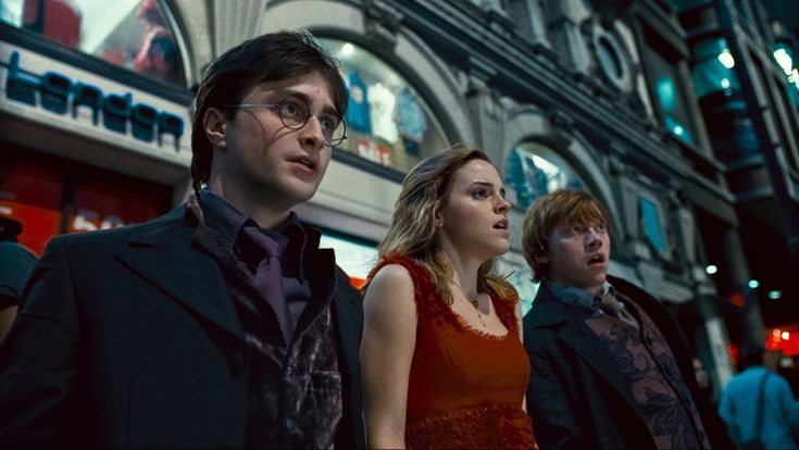 harry potter and hermione's hogwarts are standing in front of a building