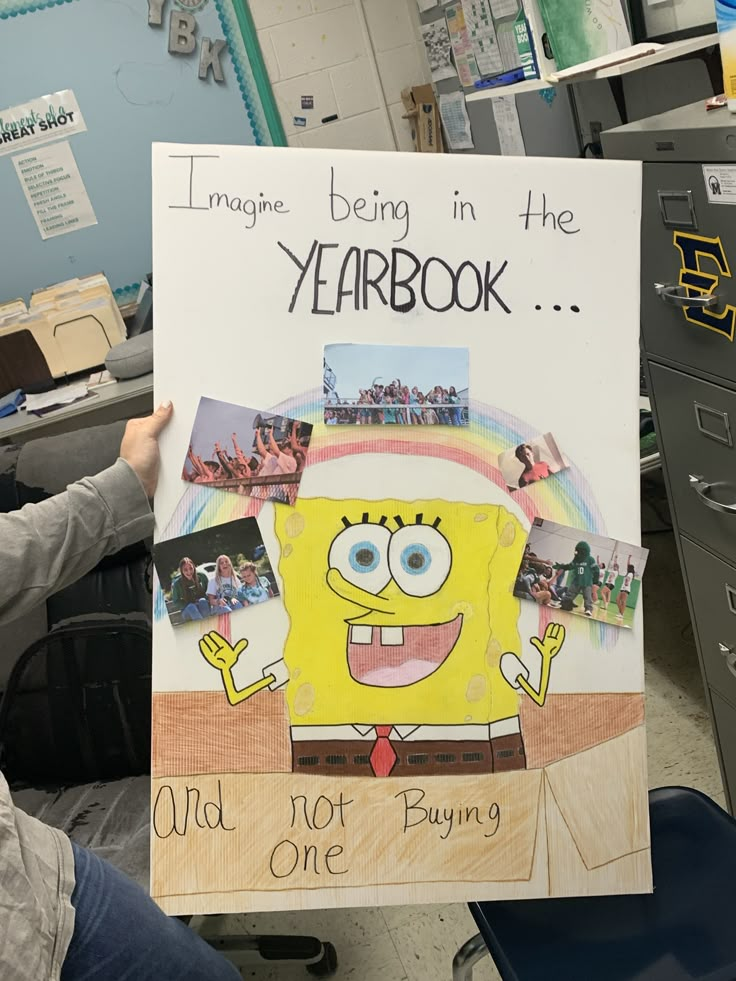 a person holding up a poster with an image of a spongebob on it