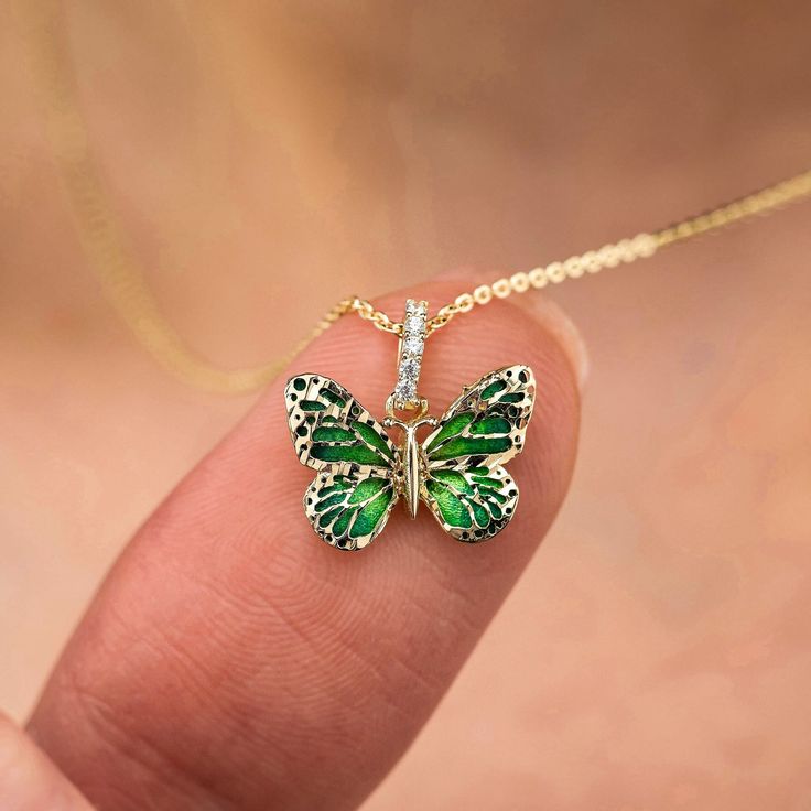 What do Butterflies symbolize? Dance Like the Butterfly Butterflies bring color and joy with them. They awaken a sense of lightness and joy. They can symbolize purity, love, grace, lightness of being, dignity, good luck, hope and unpredictability. 💕DETAILS The Green Butterfly is 1cm x 1.3cm 💕 WITH A CHAIN ---> Chain is 14k solid gold ---> The necklace can be removed from the chain. ---> The gold chain is 45cm long (approx. 18in). ---> The chain used is 0.8mm - 10mm thick (approx. 0.031in -0.04 Green Butterfly Charm Necklace, Elegant Green Butterfly Necklace As Gift, Elegant Green Butterfly Necklace For Gift, Elegant Green Butterfly Necklace Perfect For Gifts, Elegant Green Butterfly Necklace, Green Butterfly Jewelry For Gifts, Green Butterfly Jewelry For Gift, Green Jewelry With Butterfly Charm For Gift, Butterflies Symbolize