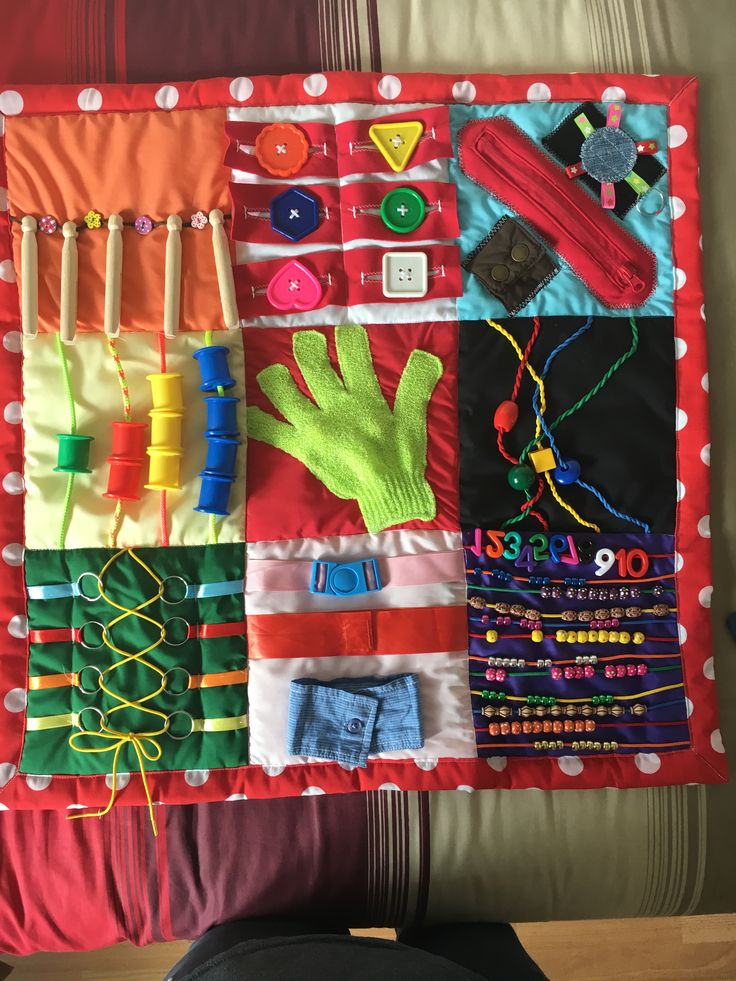 a child's play mat with many different items on it