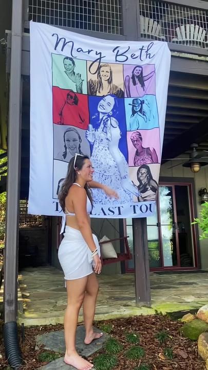 a woman standing in front of a banner with pictures on it that says, merry belt