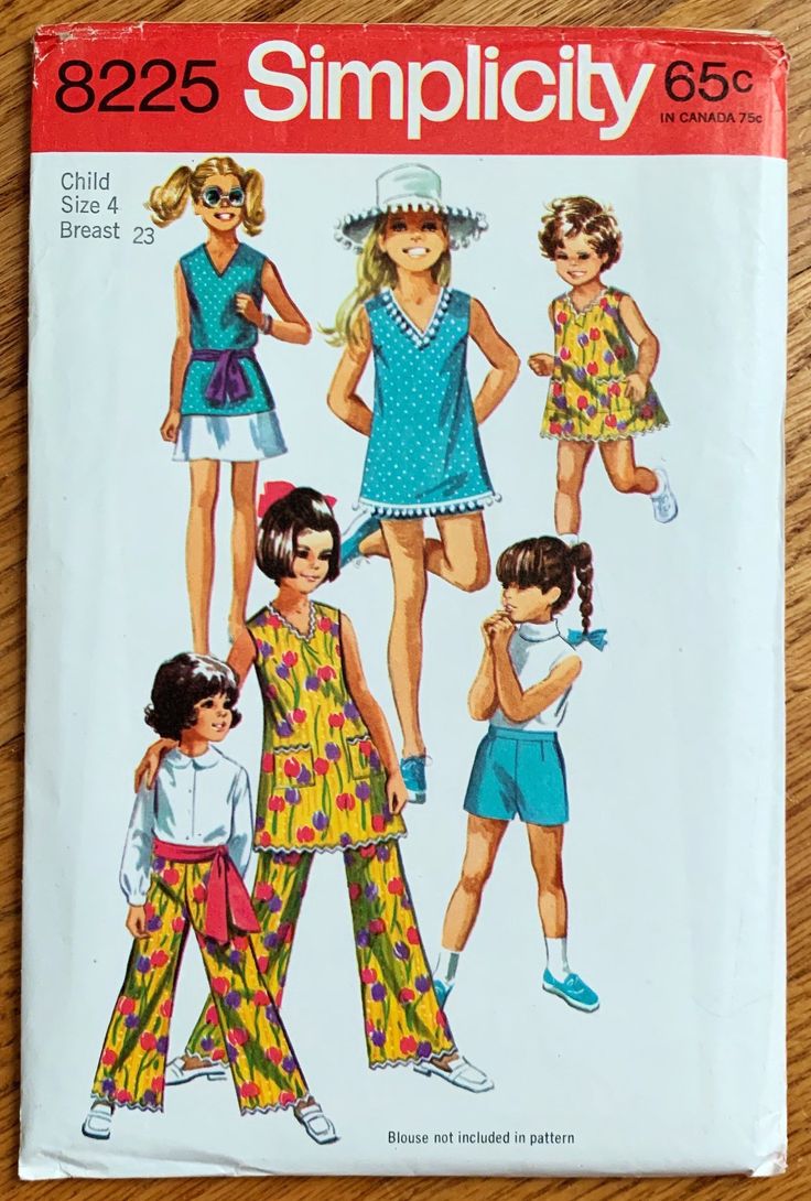 an image of children's dress and pants sewing pattern on a wooden surface with the words, 8225 simpl city