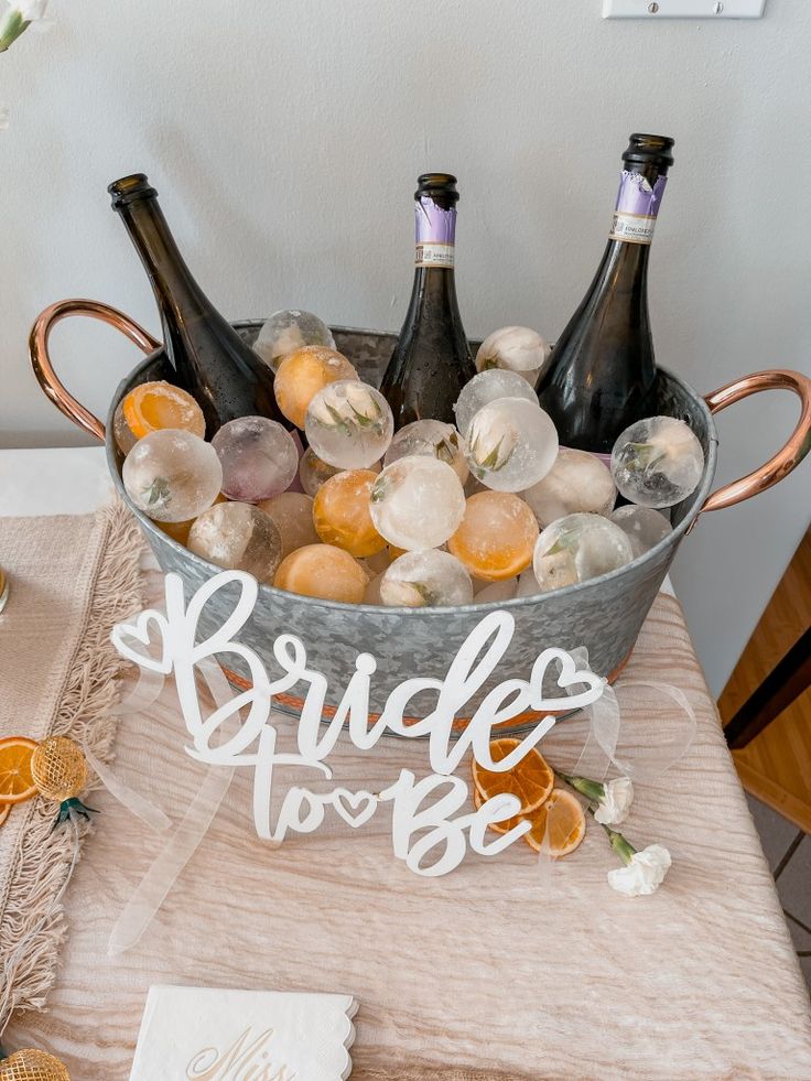 a bucket filled with bottles of wine on top of a table