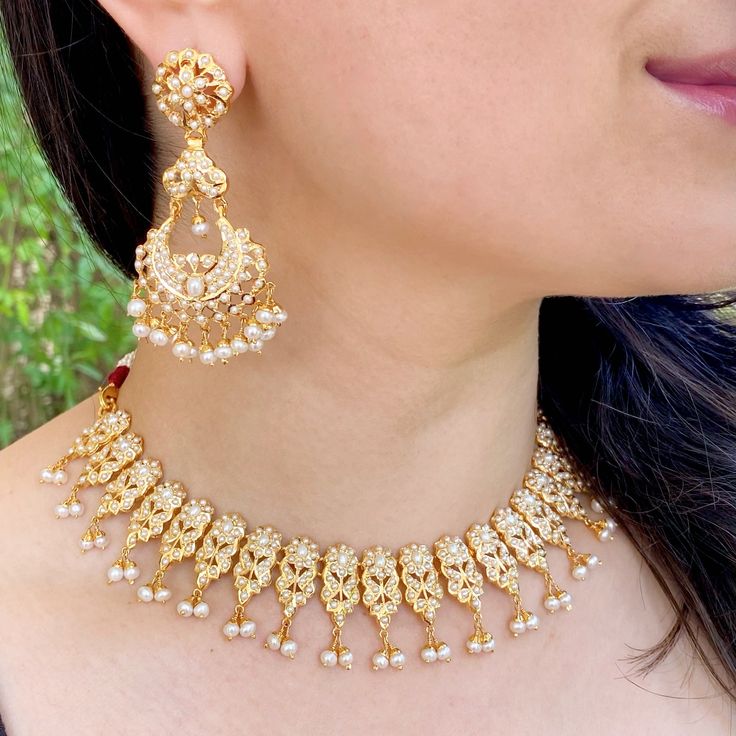 Featuring a jadau necklace matched with a pair of long chanbali style earrings. It has been embellished with precious freshwater pearls. The necklace is supplied with a fancy tassel/dori and the earrings close with a bombay screw. Elegant Kundan Necklace With Latkans For Diwali, Elegant Chandbali Bridal Necklace With Latkans, Temple Jewelry Bridal Necklace With Latkans For Eid, Elegant Pearl Necklace With Latkans For Diwali, Elegant Pearl Necklace With Latkans For Festivals, Elegant White Temple Necklace With Latkans, Elegant Chandbalis For Eid Ceremonies, Elegant Kundan Necklace With Latkans For Festivals, Elegant Chandbali Kundan Necklace With Latkans