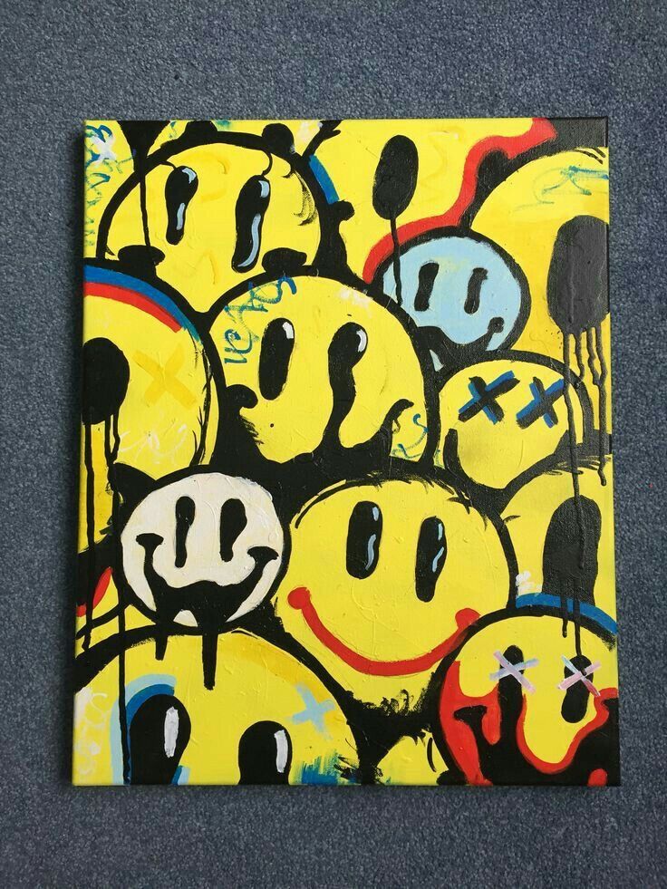 a painting with many smiley faces painted on it