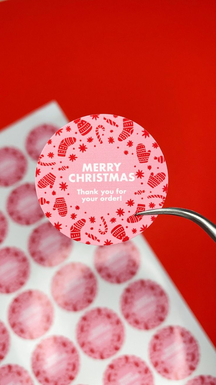 a close up of a sticker on the handle of a carton of christmas cookies