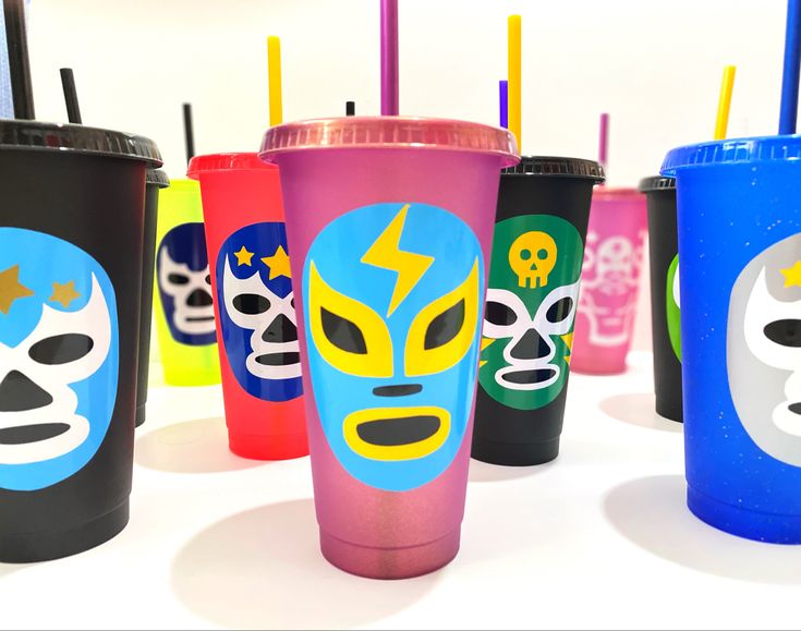 many different colored cups with designs on them