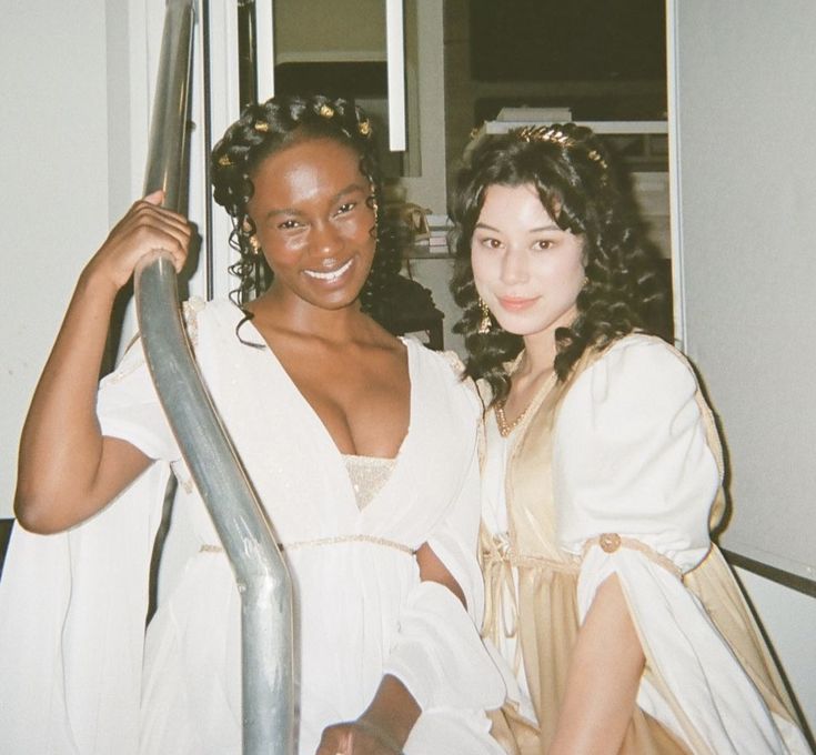 two women dressed in roman garb posing for the camera