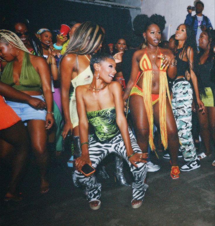 group of women in colorful outfits dancing at a party