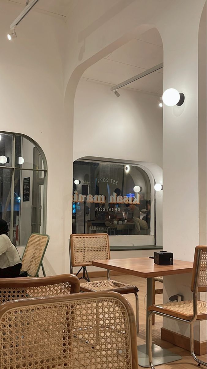 an indoor cafe with wicker chairs and tables