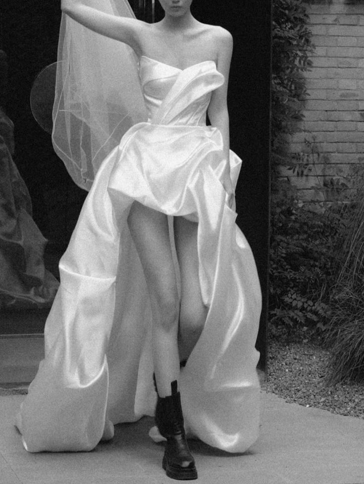 a black and white photo of a woman in a wedding dress