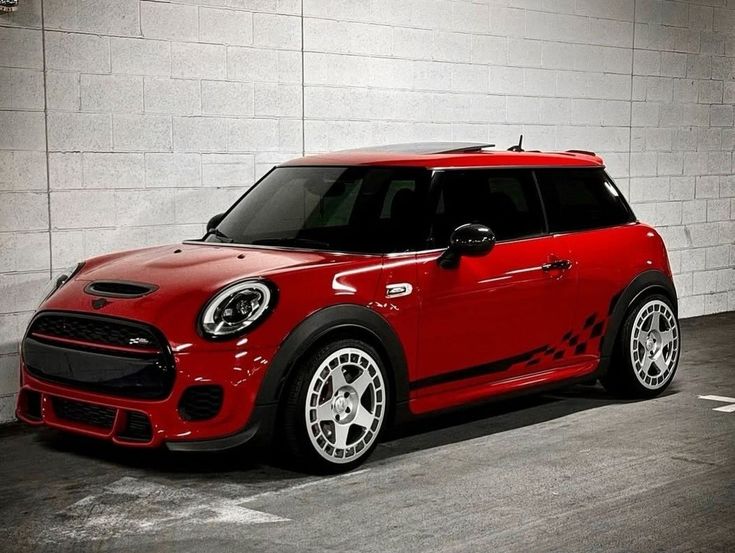 a red mini cooper parked in a parking garage