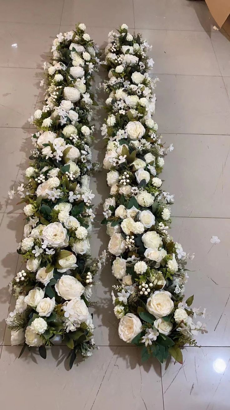 two rows of white flowers on the floor