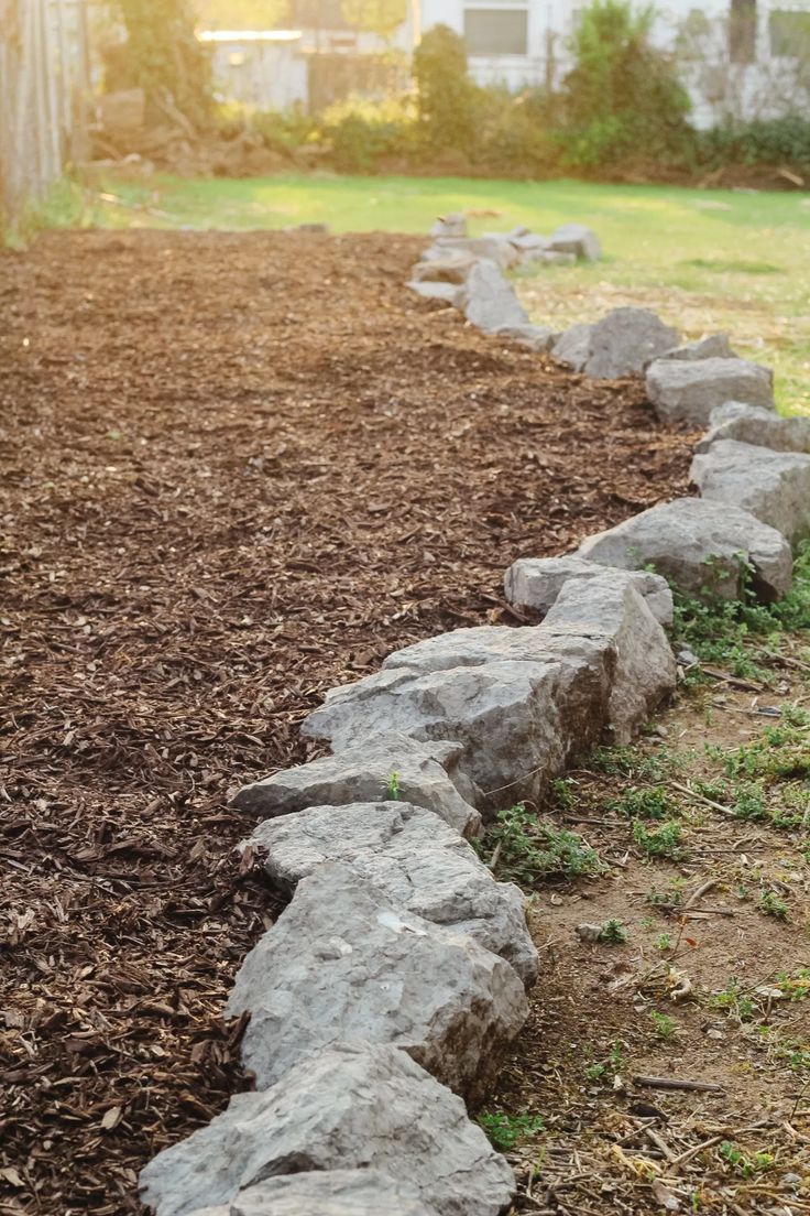 a row of rocks sitting in the middle of a field