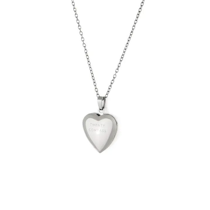 The All My Love Locket is a twist on a classic - a heart shaped locket on a minimalist chain. This timeless piece captures the romantic nostalgia of treasured memories. Stainless steel 18'' + 2'' adjustable chain Hypoallergenic *Please note that 'Twenty Compass' is etched into the back of the locket. Keepsake Heart Pendant Necklace In Stainless Steel, Stainless Steel Keepsake Necklaces For Valentine's Day, Heart Pendant Necklace In Stainless Steel For Keepsake, Stainless Steel Heart Pendant Necklace For Keepsake, Heart-shaped Keepsake Stainless Steel Necklaces, Heart-shaped Stainless Steel Keepsake Necklaces, Keepsake Heart Pendant Locket Necklace With Adjustable Chain, Heart Pendant Locket Necklace For Keepsake With Adjustable Chain, Stainless Steel Locket Necklace For Keepsake