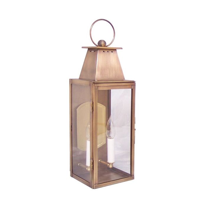 an old fashioned brass lantern with two candles