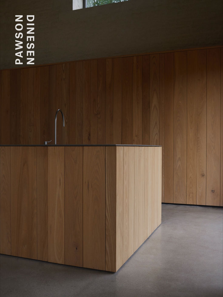 an empty kitchen with wooden cabinets and a stainless steel faucet in the center