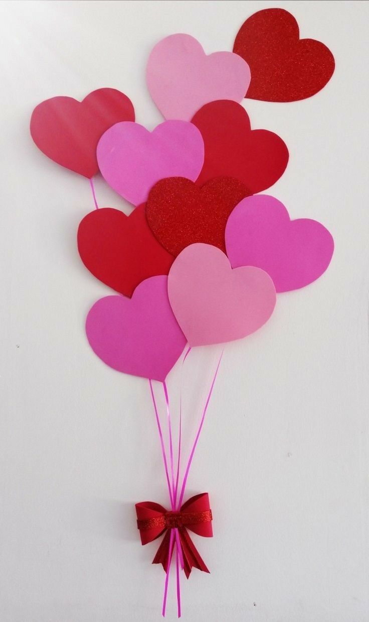 valentine's day heart balloons are hanging on the wall