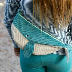 a woman with her back to the camera holding a blue and white purse in her hands