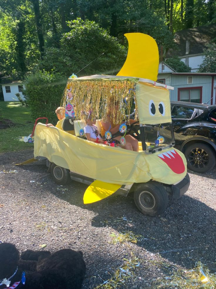 a banana boat float is parked on the gravel