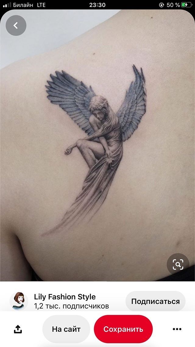 the back of a woman's shoulder with an angel tattoo on it